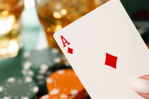 Female hand holding playing cards in casino close up